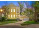 Charming yellow two-story home with a detached two car garage and mature trees at 1002 Blockade Runner Ct, Charleston, SC 29414