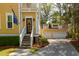 Inviting home exterior featuring covered porch, garage and professional landscaping at 1002 Blockade Runner Ct, Charleston, SC 29414