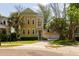 Charming yellow two-story home with a detached two car garage and mature trees at 1002 Blockade Runner Ct, Charleston, SC 29414