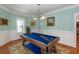 The game room showcases a blue pool table, soft lighting, and traditional decor for leisure and entertainment at 1002 Blockade Runner Ct, Charleston, SC 29414