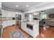 Open kitchen view with stainless steel appliances, white cabinets, granite counters, and an attached living room at 1002 Blockade Runner Ct, Charleston, SC 29414