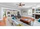 Open-concept living room and kitchen featuring hardwood floors, white cabinets, and stylish furniture at 1002 Blockade Runner Ct, Charleston, SC 29414