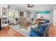 Comfortable living room featuring a large sectional sofa, wooden floors, and a decorative rug at 1002 Blockade Runner Ct, Charleston, SC 29414