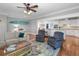 Inviting living room with hardwood floors, a stylish rug, and a surfboard wall decoration at 1002 Blockade Runner Ct, Charleston, SC 29414