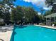 Community pool featuring clear water, surrounding trees, lounge chairs, and shade for relaxing summer afternoons at 1002 Blockade Runner Ct, Charleston, SC 29414
