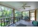 Relaxing covered porch with ceiling fan, comfortable seating, and view of the trees at 1002 Blockade Runner Ct, Charleston, SC 29414