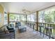 Relaxing covered porch with ceiling fan, comfortable seating, and view of the backyard at 1002 Blockade Runner Ct, Charleston, SC 29414