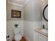 Neat powder room featuring wainscoting and a round mirror at 1002 Blockade Runner Ct, Charleston, SC 29414