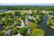 Aerial view of a residential neighborhood with homes nestled among lush trees and a lake nearby at 1006 Wayfarer Ln, Charleston, SC 29412