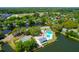 Aerial view of a neighborhood featuring a pool, tennis courts, ponds, and lush green landscaping at 1006 Wayfarer Ln, Charleston, SC 29412