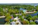Aerial view of a home nestled amongst lush trees and a community with a pond at 1006 Wayfarer Ln, Charleston, SC 29412