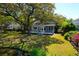 Secluded home features a beautiful backyard surrounded by lush greenery and a tranquil pond at 1006 Wayfarer Ln, Charleston, SC 29412