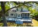 Spacious backyard featuring a large deck, screened-in porch and mature trees at 1006 Wayfarer Ln, Charleston, SC 29412