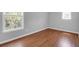 Bright bedroom features wood floors, neutral walls, and a large window for ample natural light at 1006 Wayfarer Ln, Charleston, SC 29412