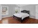 Bedroom features wood-look floors, white trim and a large window at 1006 Wayfarer Ln, Charleston, SC 29412