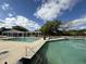Community pool with pergola and clear blue skies, surrounded by lush greenery, offers a refreshing and relaxing experience at 1006 Wayfarer Ln, Charleston, SC 29412