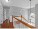 Hallway features wood-look floors, white-painted stairs and lots of natural light at 1006 Wayfarer Ln, Charleston, SC 29412