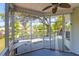 Relaxing screened porch with a view of the lake and backyard, perfect for enjoying the outdoors at 1006 Wayfarer Ln, Charleston, SC 29412