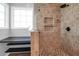 Custom tiled shower features built-in shelves, dual shower heads and glass block window at 1006 Wayfarer Ln, Charleston, SC 29412