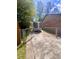 Gated driveway and backyard with brick house; secure parking or storage area at 1009 Highland Pines Rd, Ladson, SC 29456