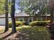 Welcoming single-story brick home with a well-maintained front yard, lush bushes, and attractive green shutters at 1009 Highland Pines Rd, Ladson, SC 29456