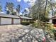 Charming brick home with two-car garage, mature landscaping, and a long driveway at 1009 Highland Pines Rd, Ladson, SC 29456
