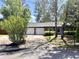 Charming single-story home with a two car garage, well-maintained lawn and mature trees at 1009 Highland Pines Rd, Ladson, SC 29456