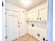 Bright laundry room features a white door, built-in cabinets, and washer/dryer hookups at 1009 Highland Pines Rd, Ladson, SC 29456