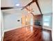 Spacious living room featuring hardwood floors, exposed wood beams, and a brick fireplace at 1009 Highland Pines Rd, Ladson, SC 29456