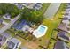 Aerial view of community pool, pond, clubhouse, and parking surrounded by well-maintained homes and landscaping at 102 Vango Dr, Goose Creek, SC 29445