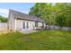 Spacious backyard with a basketball court, a patio, lush green grass, and a wooden fence surrounding the perimeter at 102 Vango Dr, Goose Creek, SC 29445