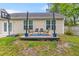 Backyard featuring a wooden deck with rocking chairs, a basketball hoop, and a view of the home's exterior at 102 Vango Dr, Goose Creek, SC 29445
