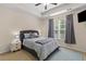 Cozy bedroom featuring a tray ceiling, plush bedding, and a window with natural light at 102 Vango Dr, Goose Creek, SC 29445
