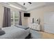 Spacious bedroom featuring a ceiling fan, large window and white dresser with mirror at 102 Vango Dr, Goose Creek, SC 29445