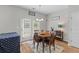 Bright dining room with a wood table set, natural light, and a door leading to the backyard at 102 Vango Dr, Goose Creek, SC 29445