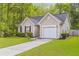 View of charming home with green grass, driveway and a one car garage at 102 Vango Dr, Goose Creek, SC 29445