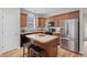 Modern kitchen featuring dark cabinetry, granite countertops, stainless steel appliances, and a center island at 102 Vango Dr, Goose Creek, SC 29445