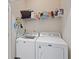 Functional laundry room equipped with a washer, dryer, and overhead shelving for storage at 102 Vango Dr, Goose Creek, SC 29445