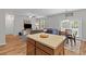 Open living room featuring hardwood floors, modern decor and an island with granite countertops at 102 Vango Dr, Goose Creek, SC 29445
