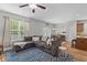 Open-concept living room with natural light, a comfortable sofa, and adjoins to a dining area and kitchen at 102 Vango Dr, Goose Creek, SC 29445