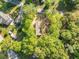 Overhead view of a home nestled among mature trees, providing privacy and natural beauty at 103 Bush Dr, Bonneau, SC 29431