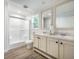 Well-lit bathroom featuring a double vanity, shower, and modern fixtures at 103 Bush Dr, Bonneau, SC 29431