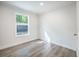 Cozy bedroom with ample natural light streaming through the window, complemented by modern flooring at 103 Bush Dr, Bonneau, SC 29431