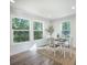 Sunlit dining area with large windows, a modern table, and a view of the outdoors at 103 Bush Dr, Bonneau, SC 29431