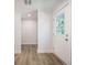 Bright entryway featuring durable wood-look flooring and a welcoming white front door with window panes at 103 Bush Dr, Bonneau, SC 29431