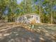 Picturesque home with a charming porch, set among beautiful trees, creating a tranquil and inviting atmosphere at 103 Bush Dr, Bonneau, SC 29431