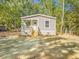 Inviting home with a quaint porch, nestled in a serene environment, offering a harmonious living space at 103 Bush Dr, Bonneau, SC 29431