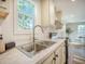 Bright kitchen featuring a stainless steel sink, modern faucet, and a view from the window at 103 Bush Dr, Bonneau, SC 29431