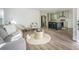 Open concept living area with an island kitchen, seating, and hardwood floors at 103 Bush Dr, Bonneau, SC 29431