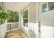 Covered porch with wood flooring and white railing at 103 Bush Dr, Bonneau, SC 29431